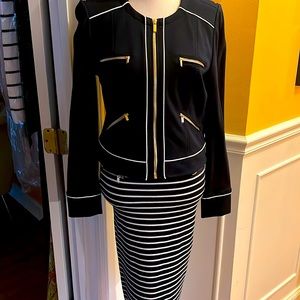2pc navy blue suit. Never worn. Zippers on jacket and skirt. Back zip